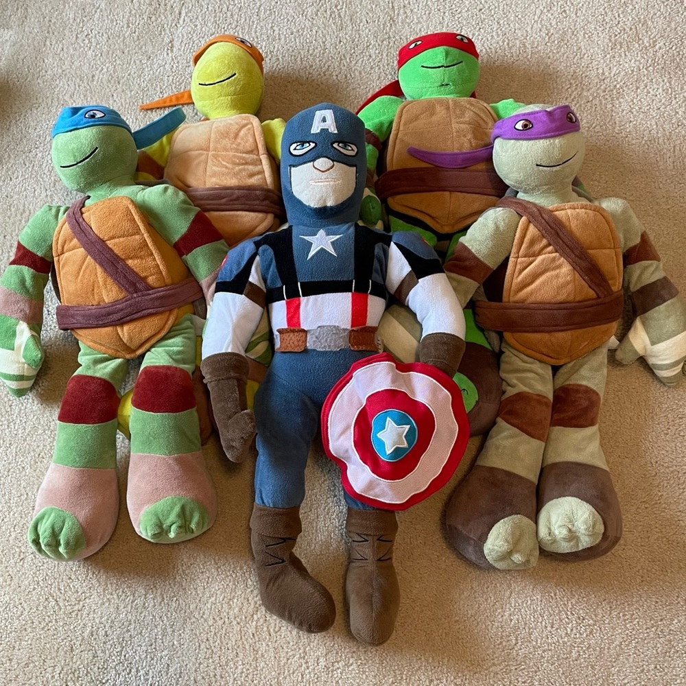 Large Teenage Mutant Ninja Turtle and Captain America plush toys.